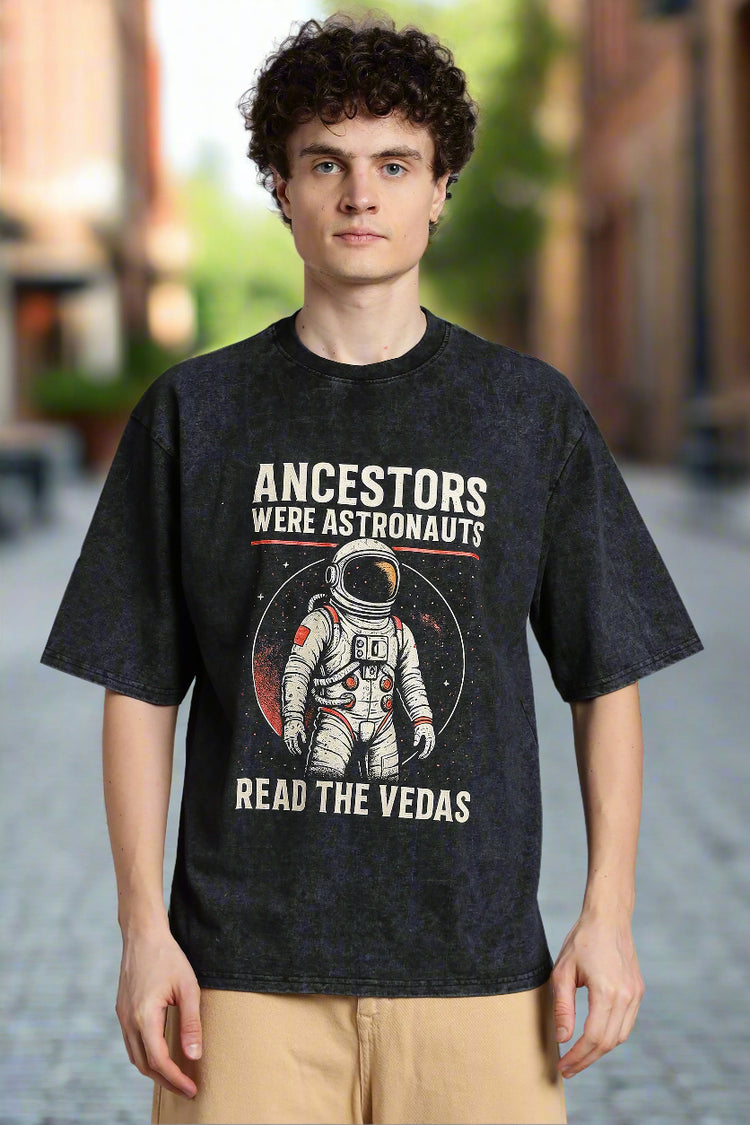 Graphic acid wash T-shirt with “The Ancestors Were Astronauts” text, inspired by ancient astronaut theory. Modern fit, heritage meets sci-fi design.