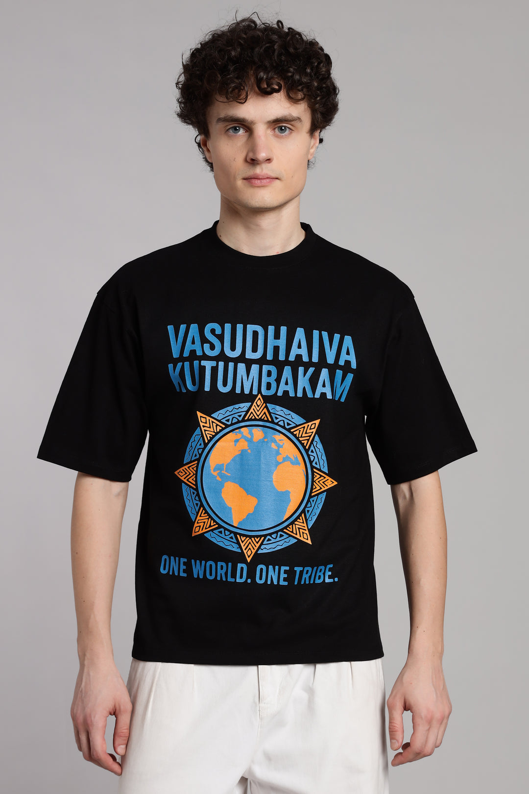 Black Vasudhaiva Kutumbakam T-shirt with ‘One World. One Tribe’ graphic, modern Indian streetwear rooted in unity and Upanishadic philosophy